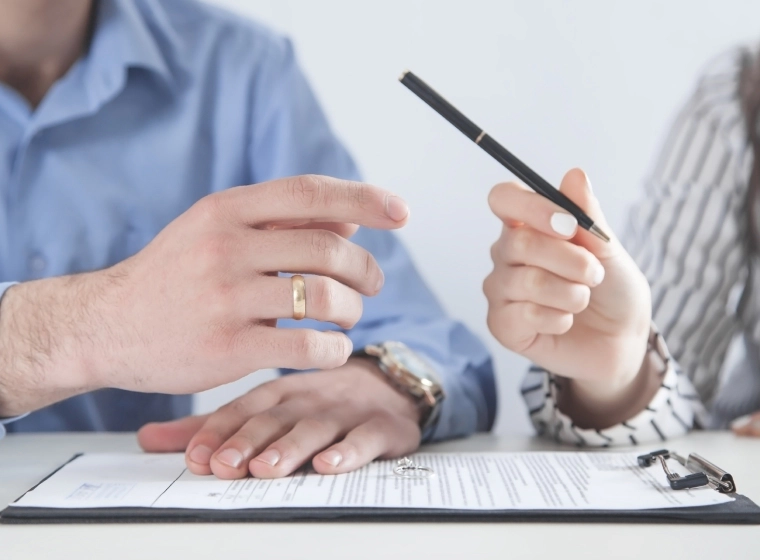 woman giving pen to man divorce appraisal contract plymouth MI